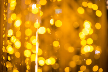 close-up blurred photo Golden decorative lights create a luxurious atmosphere at night events. Helps to take beautiful