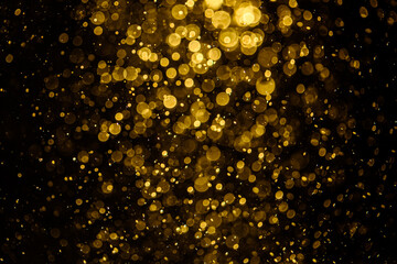 Blurred photo with golden dots visible glittering, shining brightly look and feel luxurious