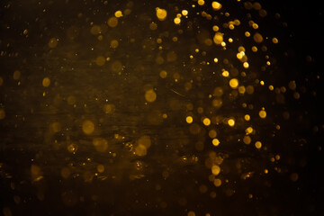 Blurred photo with golden dots visible glittering, shining brightly look and feel luxurious Suitable for use as a wallpaper