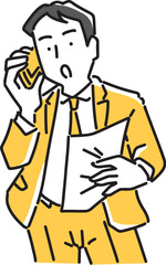 書類を見ながらスマホで話すビジネスマン