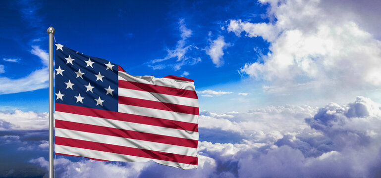 United States national flag cloth fabric waving on beautiful Blue Sky Background.