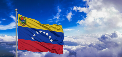 Venezuela  national flag cloth fabric waving on beautiful Blue Sky Background.