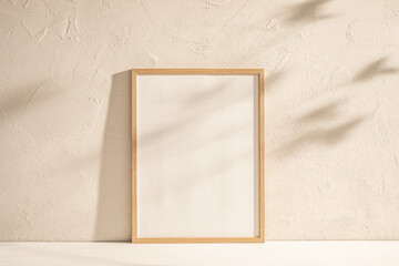 Blank Canvas in Wooden Frame Against Textured Wall in Soft Light With Shadows.