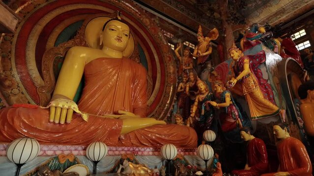 Buddha Statue among other statues and decoration of Sri Lankan buddhist temple
