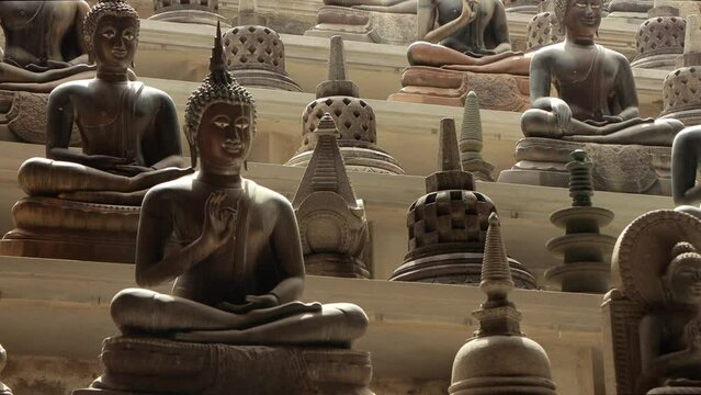 Ancient stone buddhas in Gangaramaya buddhist temple in Colombo, Sri Lanka