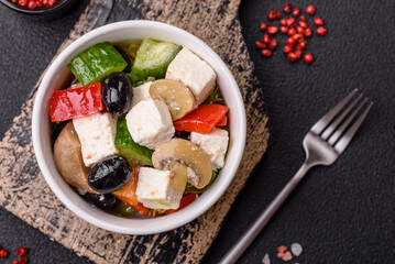 Delicious fresh juicy salad of sweet peppers, cheese, olives, tomatoes, cucumbers