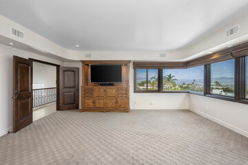 Fototapeta na wymiar Bedroom with spacious windows and a wall-mounted TV in Encino, California