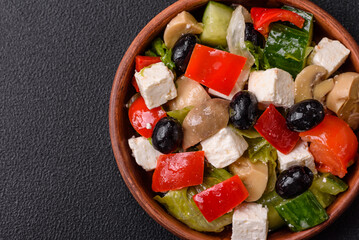 Delicious fresh juicy salad of sweet peppers, cheese, olives, tomatoes, cucumbers