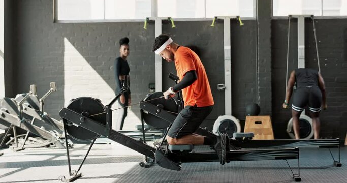 Rower, man and wellness in a gym, exercise and training with endurance and challenge with hobby. People, group and athlete with progress and rowing in a health center, active and workout with fitness