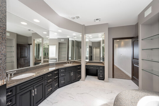 Luxurious bathroom with marble countertop and oversized mirrors in Encino, California