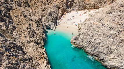 Aerial top view by drone of beach of Seitan Limania in bay with turquoise water and an unusual shape in Akrotiri, Crete. - obrazy, fototapety, plakaty