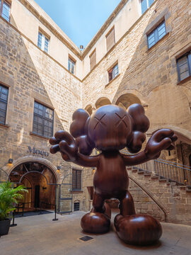 Barcelona, Spain - May 22, 2023. Moco Museum in Barcelona Spain, entrance with a statue of Brian Donnelly, known professionally as Kaws. Artist and designer of toys and costumes.