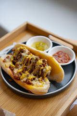 spicy chili corn dog with load of mustard, cheese and mayonnaise