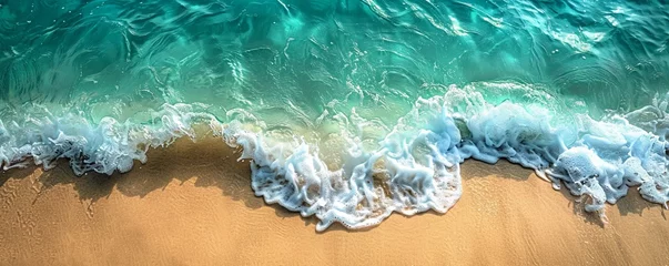 Schilderijen op glas Overhead view of crystal-clear waves lapping against a tropical beach, perfect for tranquil and serene concepts. © taelefoto