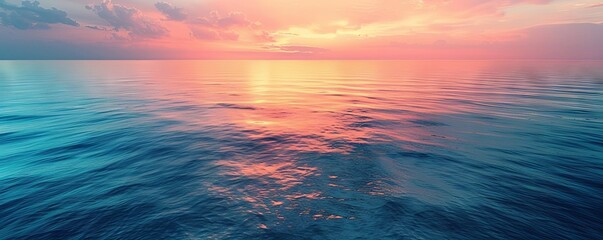 Top-down shot of a calm ocean surface reflecting the colors of the sky during sunset, ideal for peaceful and reflective themes.