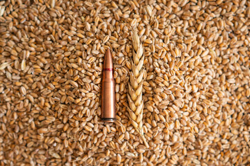Scattered Wheat Grains and Bullet Shells on a Wooden Surface