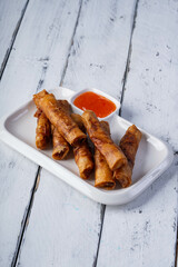 Filipino most favorite food, ground marinated pork meat wrapped in rice wrapper and serve with sweet and sour sauce, also known as lumpiang shanghai