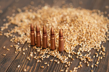 Scattered Wheat Grains and Bullet Shells on a Wooden Surface