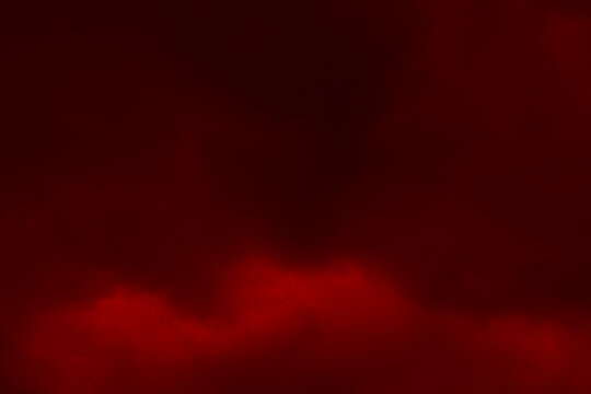 Red cloud sky texture background. Smoky cloudy air. Blurred photo of red sky with clouds. Galaxy space, New Year, Christmas, Celebrations and Environment issues background concepts. 