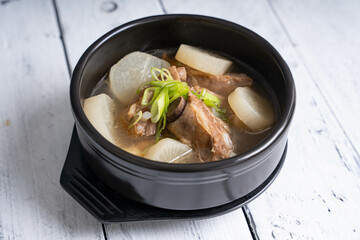 pork bone soup with sliced radish and scallions 