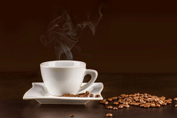 Hot coffee on a brown background with coffee beans on the table