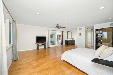 Room with hardwood floors, entertainment center, and spacious windows in Encino, CA