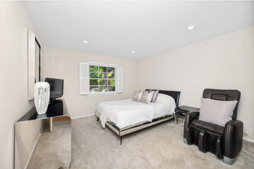 Interior shot of a room featuring a television, bed, and chair in Encino, CA