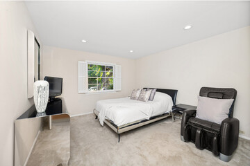 Fototapeta premium Interior shot of a room featuring a television, bed, and chair in Encino, CA