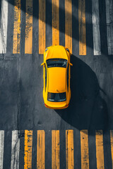 Yellow car is seen from above on street.