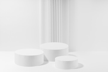 Three white round podiums with striped column as geometric decor, set, mockup on white background. Template for presentation cosmetic products, gifts, goods, advertising, design in modern style.