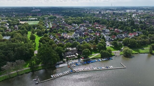 An aerial drone view of residential buildings along Aasee Lake in M&uuml;nster-Aaseestadt, Germany.