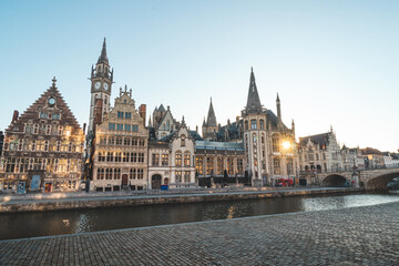 Ghent promenade called the Graslei and the charming historic houses at sunrise. The centre of the Belgian city. Flanders - obrazy, fototapety, plakaty