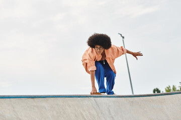 A young African American woman with curly hair riding a skateboard on a ramp at an outdoor skate...