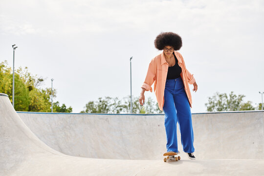 A young African American woman with curly hair skilfully rides a skateboard up the side of a ramp in a vibrant skate park.