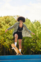 A young African American woman with curly hair skillfully skateboarding on top of a blue ramp in an...