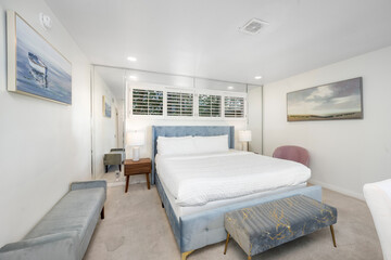 Fototapeta na wymiar Cozy room with a sofa, bed, and dresser in Hidden Hills, CA