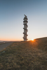 Radar Ossenisse under the sunrise rays in the south of the Netherlands. Security tower for the...