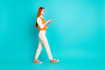 Profile photo of adorable lovely woman wear stylish orange clothes walk go empty space isolated on...