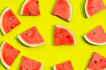Watermelon slices on green background.