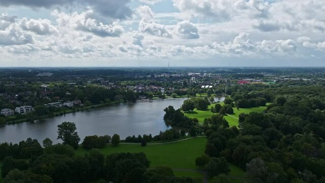 An aerial drone view of Aasee Lake in M&uuml;nster . Lake Aasee is an artificial lake located in M&uuml;nster , Germany .