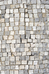 Surface covered with gray and white stone mosaic