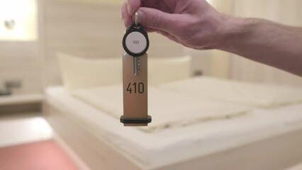 keys in male hand, hotel bedroom with neatly made bed covered in clean white linens, room rental, comfort and relaxation, Hotel Service and Hospitality, Tourism and Travel, restful night's sleep - Powered by Adobe