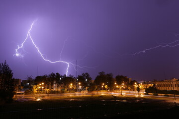 Naklejka na ściany i meble Lightning Bolt Strikes Over City at Night