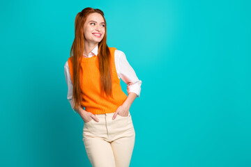 Fototapeta na wymiar Photo of lovely adorable cheerful girl wear trendy orange outfit look empty space isolated on cyan color background