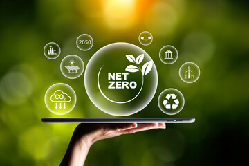 Net zero, carbon neutrality concept. Net zero and Green energy icon around it at on laptop. Green Energy Renewable Sustainable. Net zero emission Idea innovative. carbon neutrality in 2050. - obrazy, fototapety, plakaty