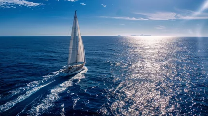 Rolgordijnen A sleek sailboat sailing gracefully across the sparkling ocean on a bright and sunny day © Ilia Nesolenyi