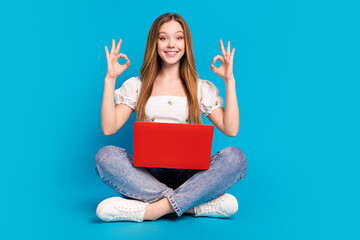 Full length portrait of lovely girl show okey symbol laptop empty space wear top isolated on blue color background