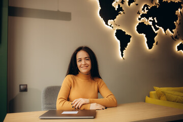 portrait of a female travel agent in the office of a travel agency