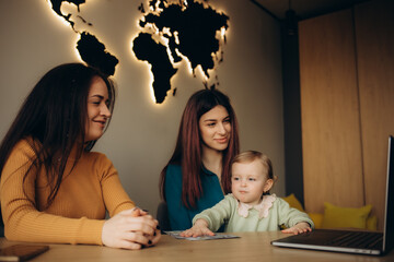 a young mother chooses a vacation in a travel agency