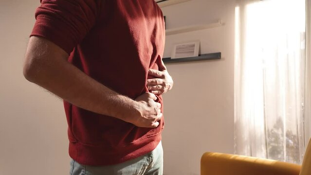 Man with chest and abdominal pain at home.